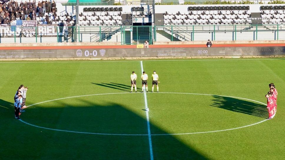 Le due squadre schierate a centrocampo per il minuto di silenzio in memoria delle vittime della tragedia di Crans Montana